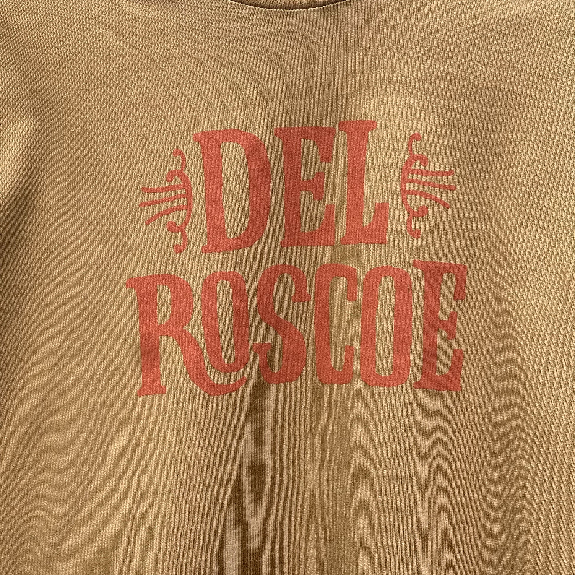Camel color t-shirt with burnt orange 'Del Roscoe' text and logo